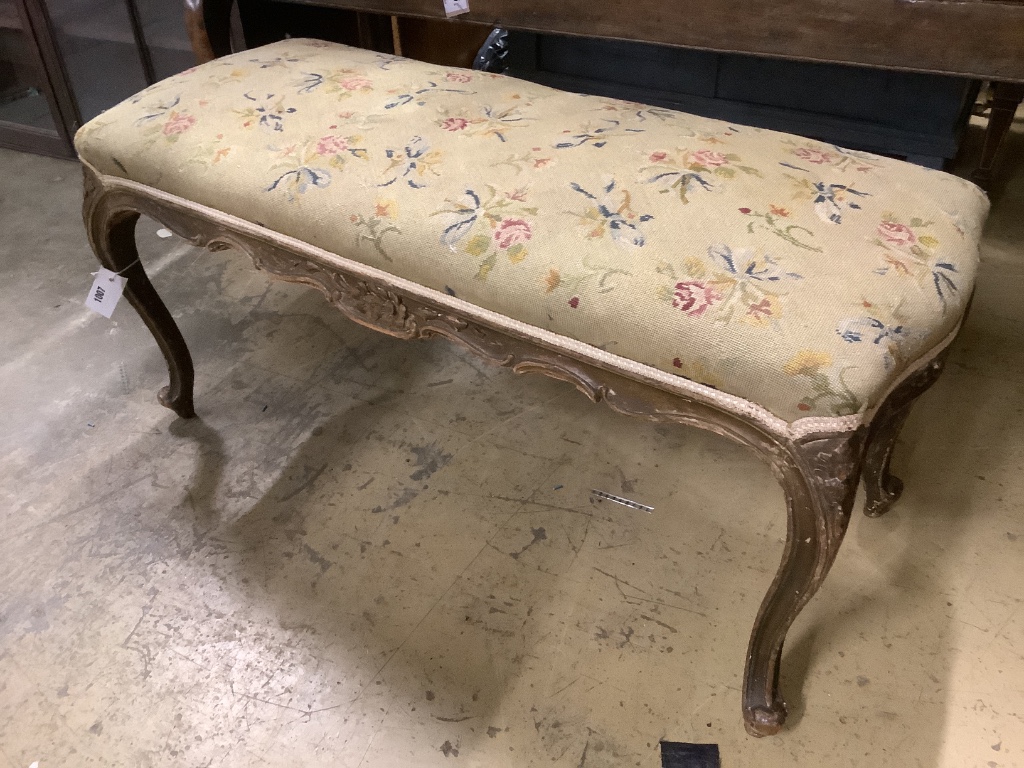 A late Victorian carved and stained beech dressing stool, width 97cm